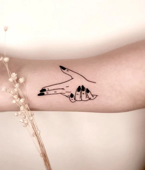 50 tatouages étonnants pour femmes, dignes d'un dur à cuire 12 Hand gun gesture tattoo on the inner arm by @ladnie.ink- Stunning Badass Tattoos For Women
