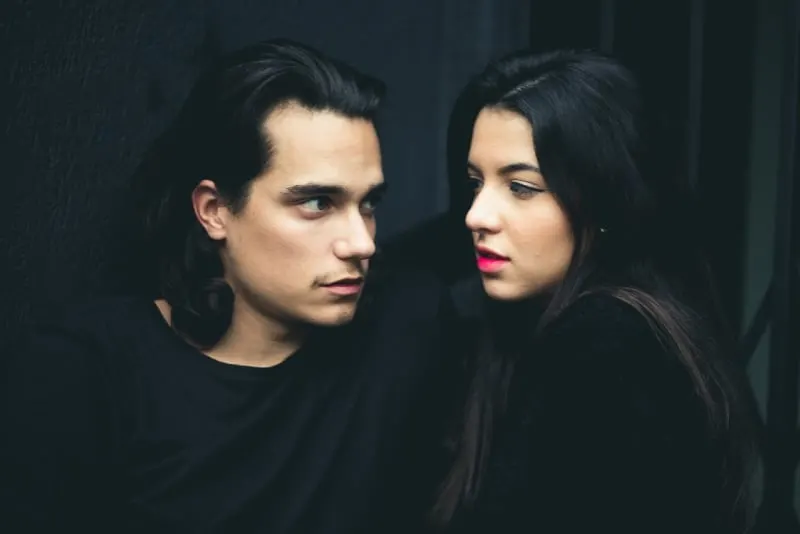 man looking at woman with red lipstick