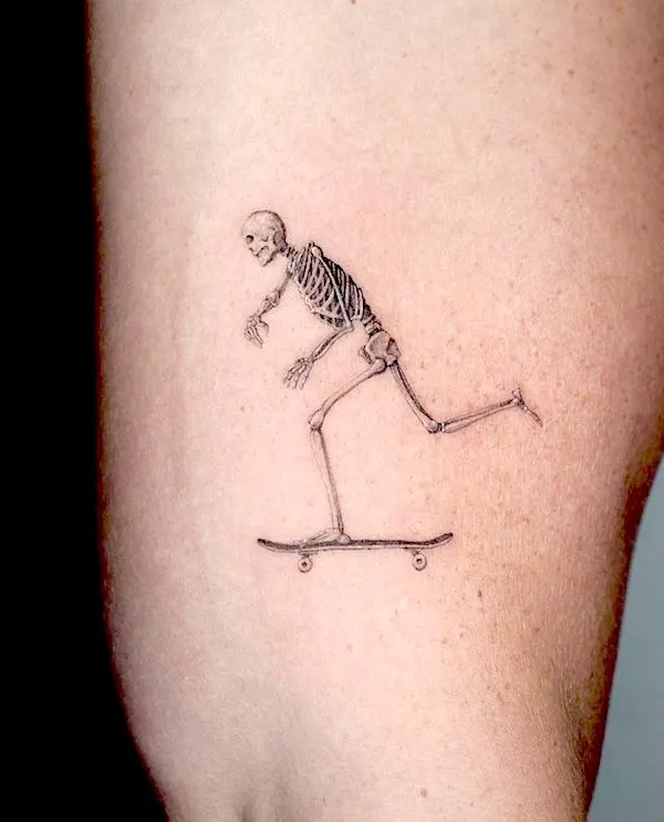 The skating skeleton tattoo by @jankyjake_tattoos