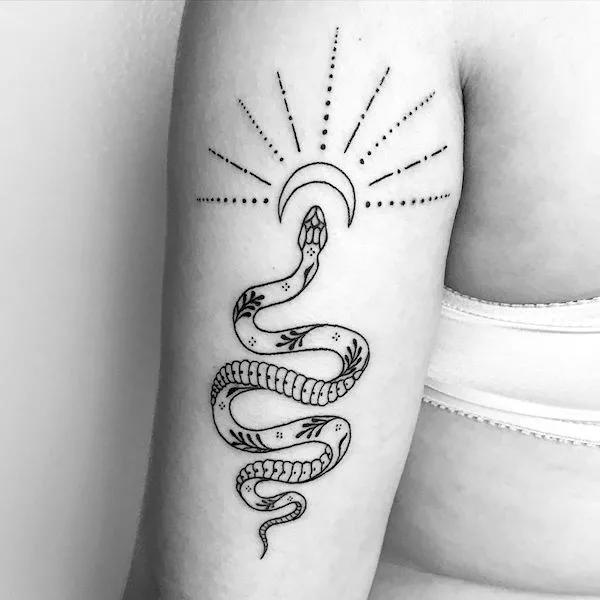 A snake tattoo by @solotattooing