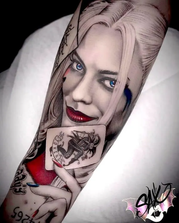 A realistic Harley Quinn portrait tattoo by @tattoosax