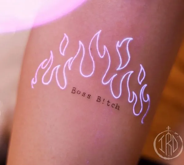 An invisible boss b*tch tattoo on the arm by @nhi.ink