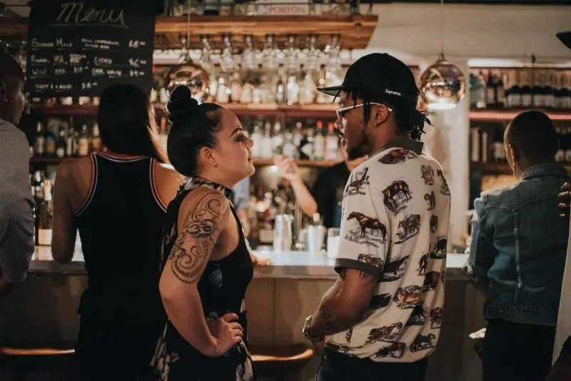 man and woman looking at each other in cafe