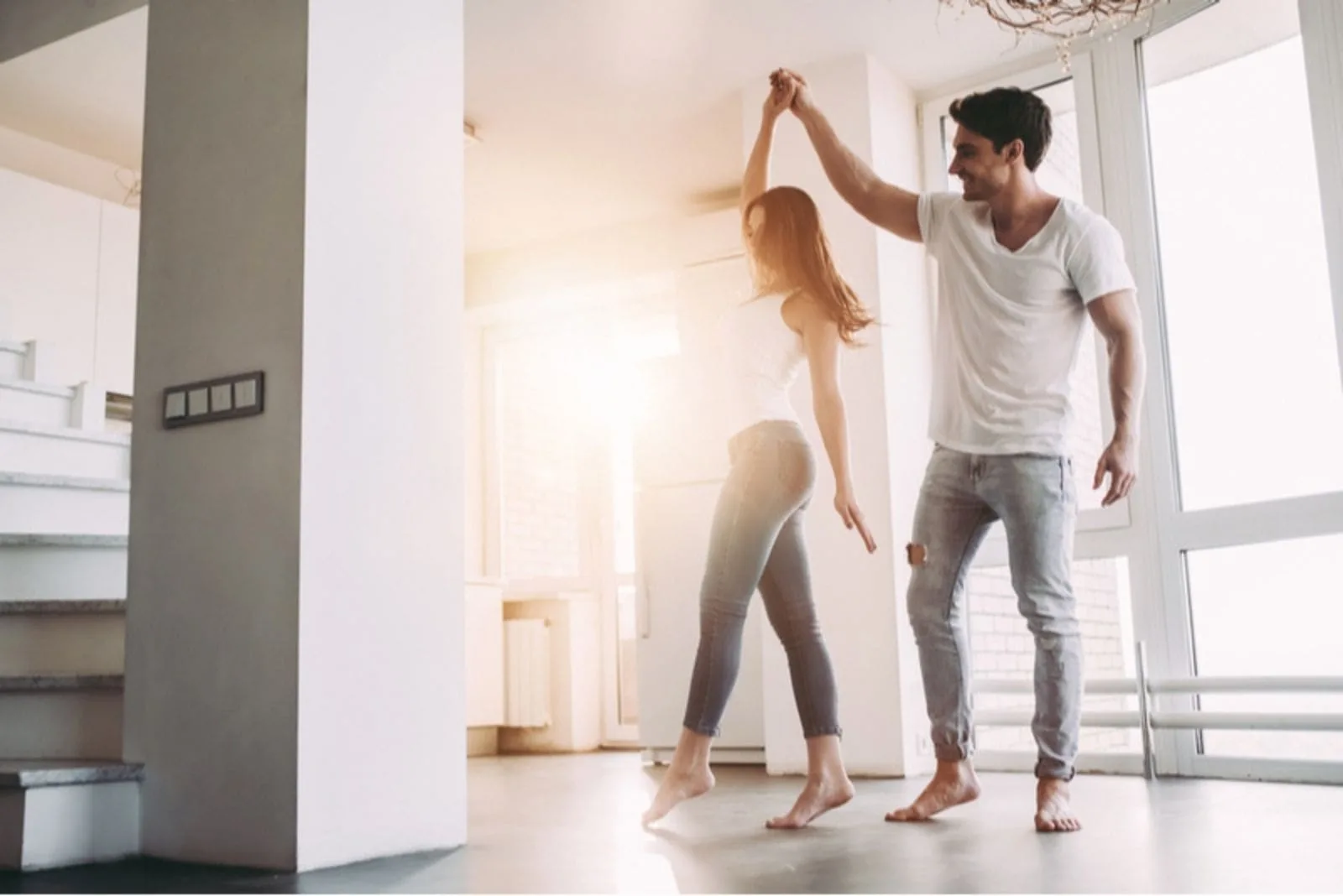 couple dancing around inside the house barefooted