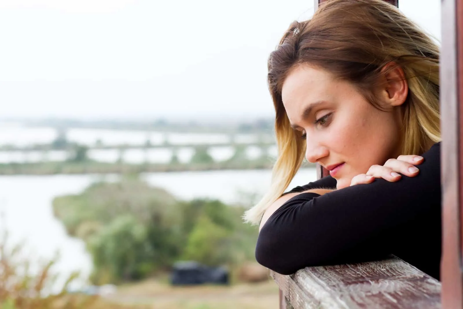 an imaginary brown-haired woman leaning against a railing