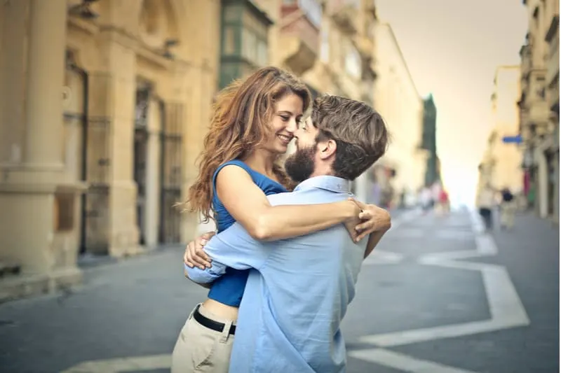 woman lifted by man in the middle of the road