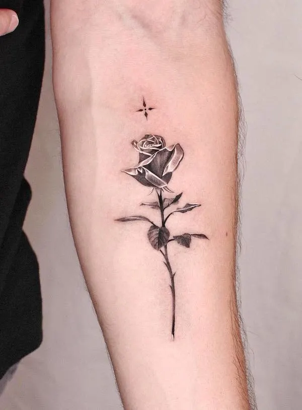Black metallic rose and star arm tattoo for women by @jku_tattoo