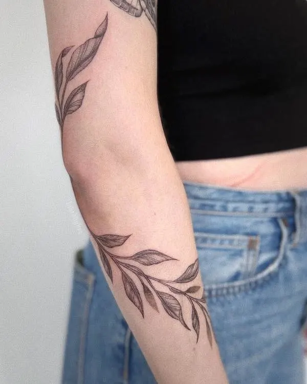 Vine tattoo wrapping around the elbow by @inkedbybre