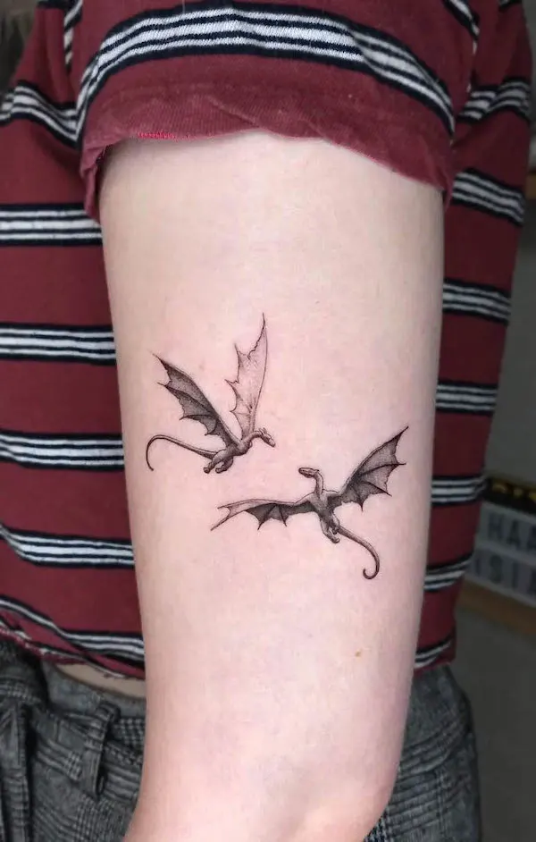Small double dragon upper arm tattoo by @kasper.august