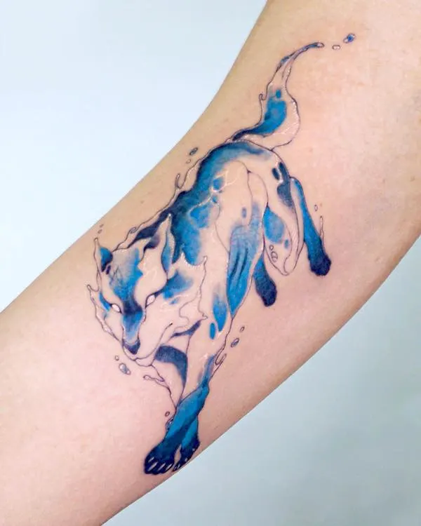 Blue wolf bicep tattoo by @tattooist.inno