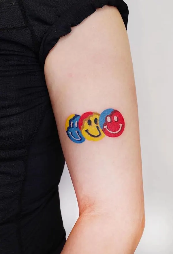 Smiley faces upper arm tattoo by @zoonmo