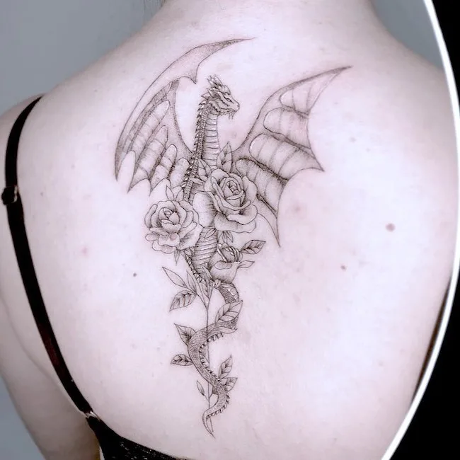 Rose and dragon tattoo by @9dotstattoo- best dragon tattoos for women and girls
