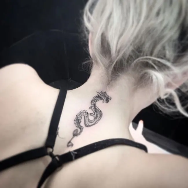 Intricate dragon neck tattoo by @enigma.tattoo.art