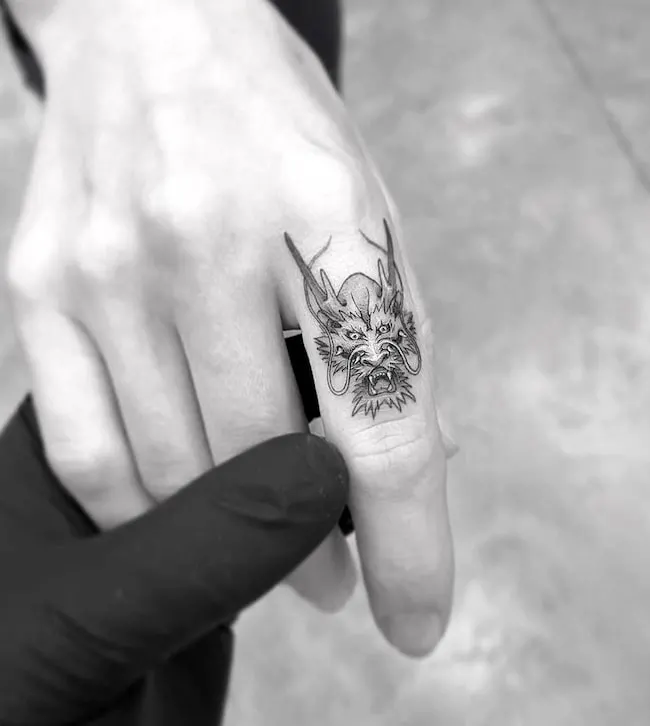 Traditional Chinese dragon finger tattoo by @tattooamazingx