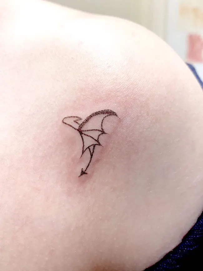 Minimalist dragon outline tattoo by @siqboi