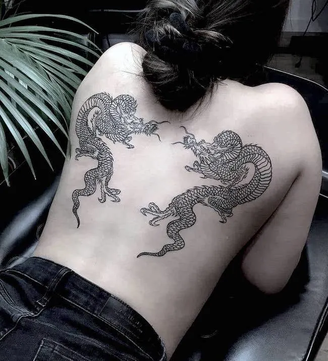 Symmetrical double dragon back tattoo by @tattoounderground_pl