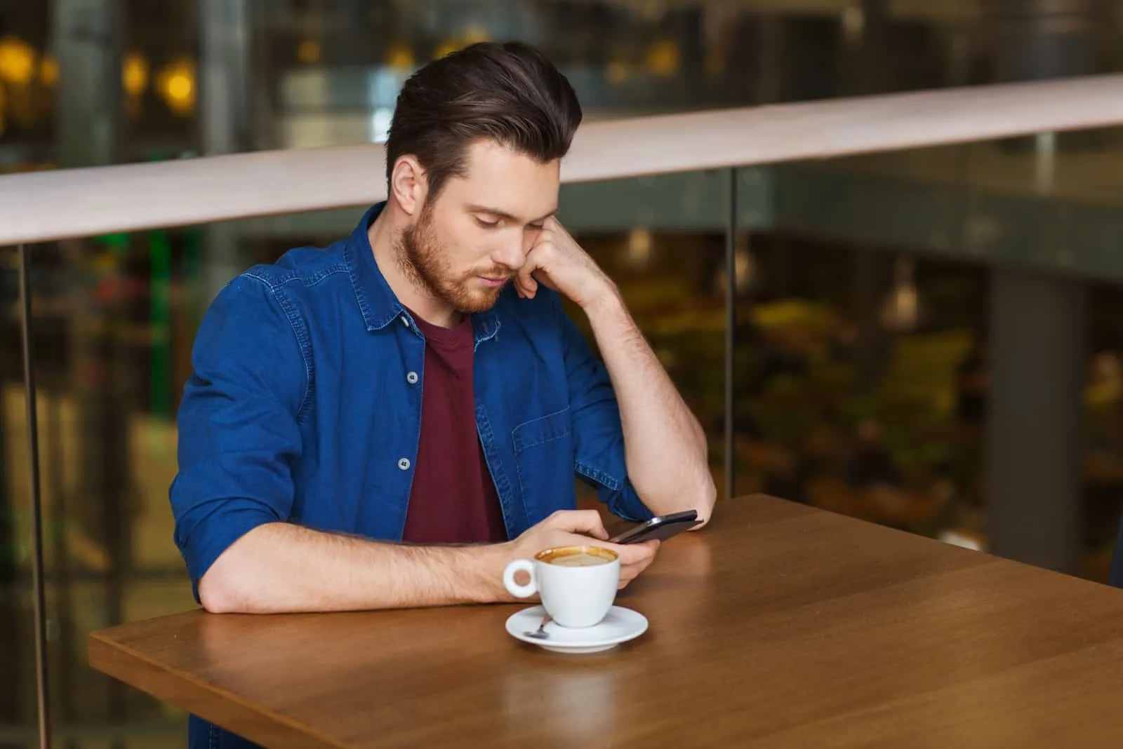 an imaginary man sits and looks at the phone