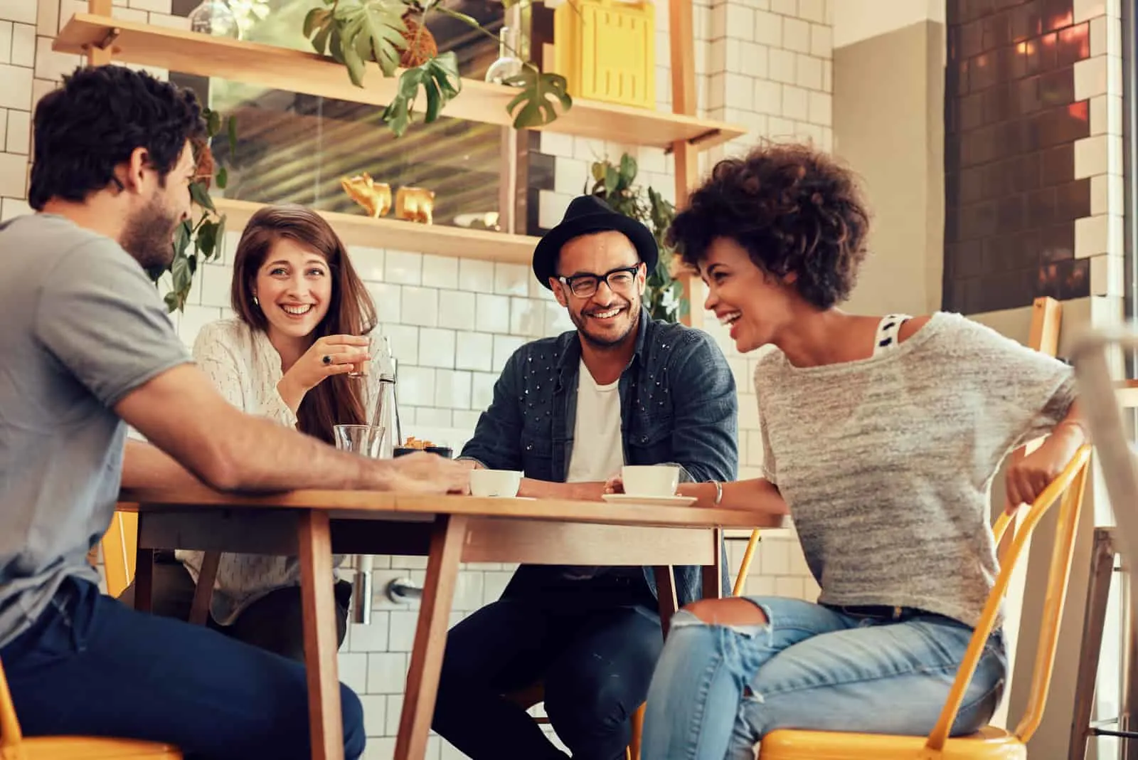 friends sit at the table and laugh